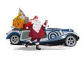 Holiday card with Santa Claus near the retro car with big bags of gifts. Royalty Free Stock Photo